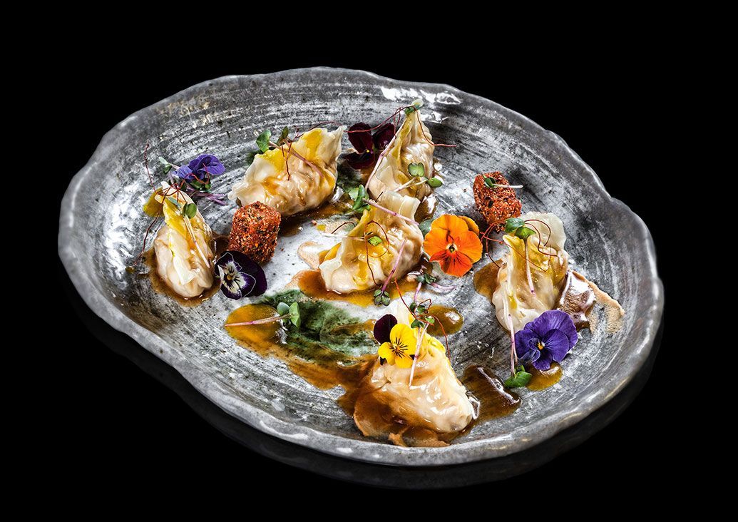 Gyozas de Pollo de Corral con Glasé de Azafrán, Almendra Tostada y Gominola Ácida de Maracuyá